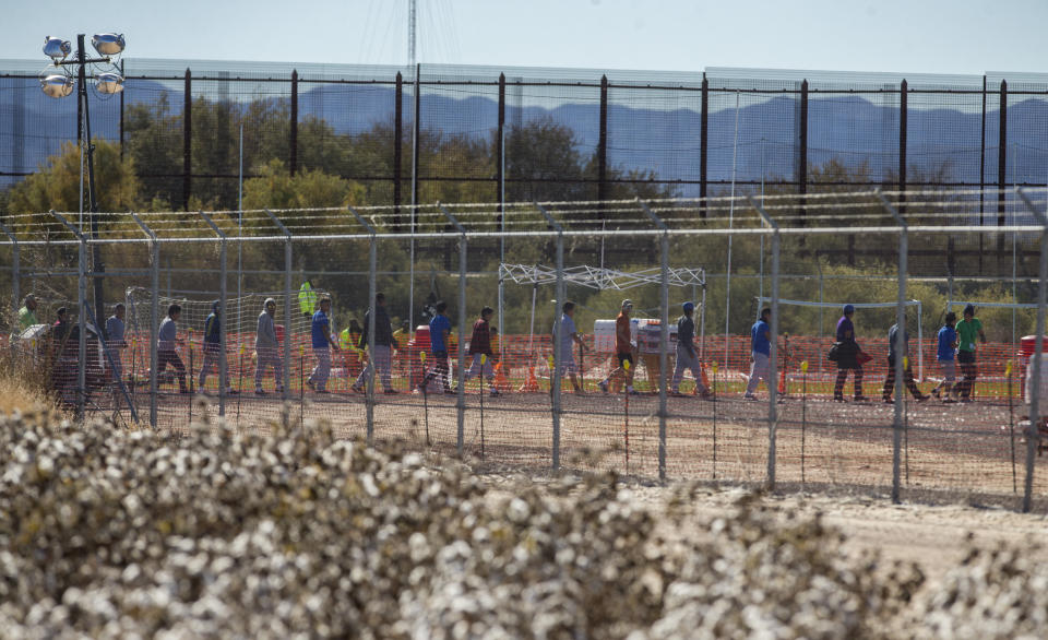 In this Nov. 15, 2018 photo provided by Ivan Pierre Aguirre, migrant teens are led in a line inside the Tornillo detention camp holding more than 2,300 migrant teens in Tornillo, Texas. The Trump administration announced in June 2018 that it would open the temporary shelter for up to 360 migrant children in this isolated corner of the Texas desert. Less than six months later, the facility has expanded into a detention camp holding thousands of teenagers - and it shows every sign of becoming more permanent. (Ivan Pierre Aguirre via AP)