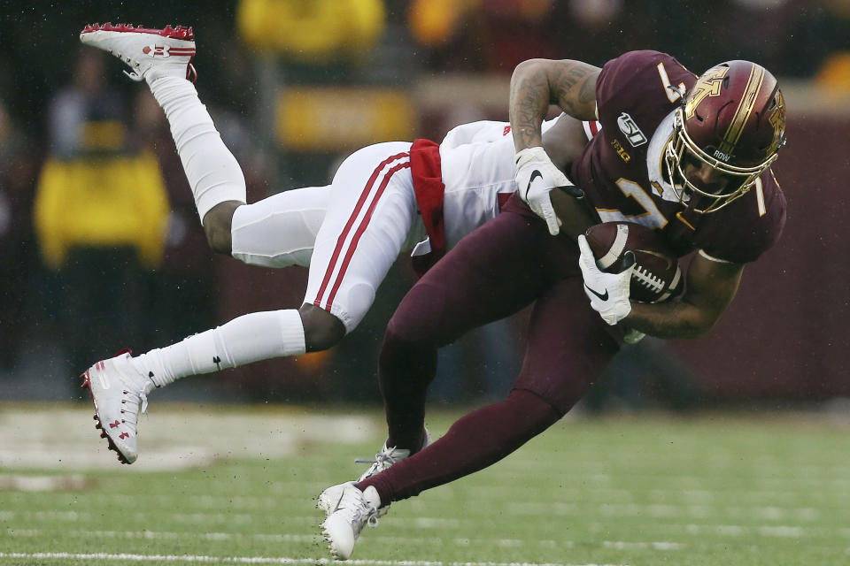 Minnesota wide receiver Chris Autman-Bell (7) is tackled by Wisconsin cornerback Semar Melvin (20) during an NCAA college football game, Saturday, Nov. 30, 2019, in Minneapolis. (AP Photo/Stacy Bengs)