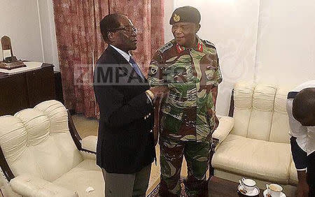 President Robert Mugabe poses with General Constantino Chiwenga at State House in Harare, Zimbabwe, November 16, 2017. ZIMPAPERS/Joseph Nyadzayo/Handout via REUTERS