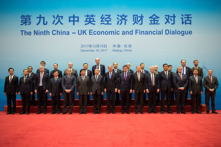 Britain's Chancellor of the Exchequer Philip Hammond and Chinese Vice Premier Ma Kai pose with delegates during the UK-China Economic Financial Dialogue at the Diaoyutai State Guesthouse in Beijing, China December 16, 2017. REUTERS/Fred Dufour/Pool