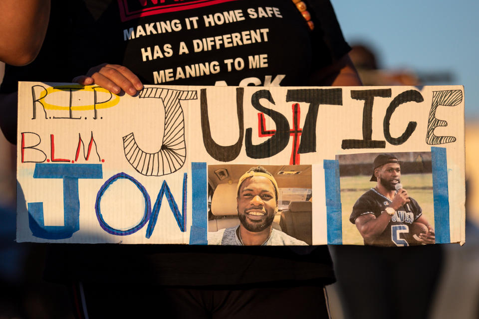 A sign with reading "Justice 4 Jon" at a candle light vigil in honor Jonathan Price. (Photo by Montinique Monroe/Getty Images)