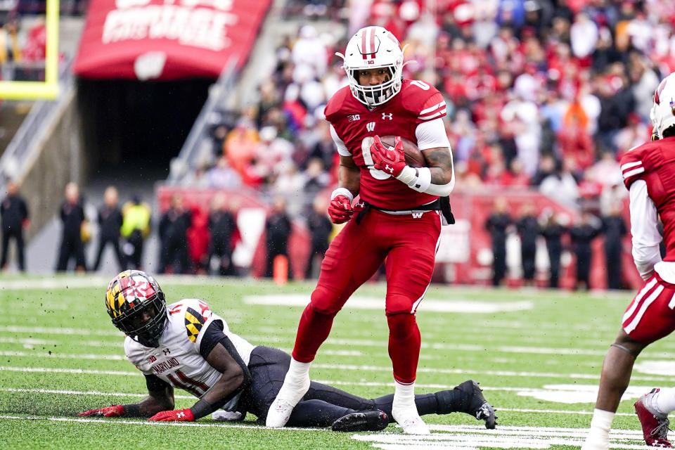 Wisconsin running back Braelon Allen (0) runs past Maryland linebacker Ruben Hyppolite (11) during the second half of an NCAA college football game Saturday, Nov. 5, 2022, in Madison, Wis. (AP Photo/Andy Manis)
