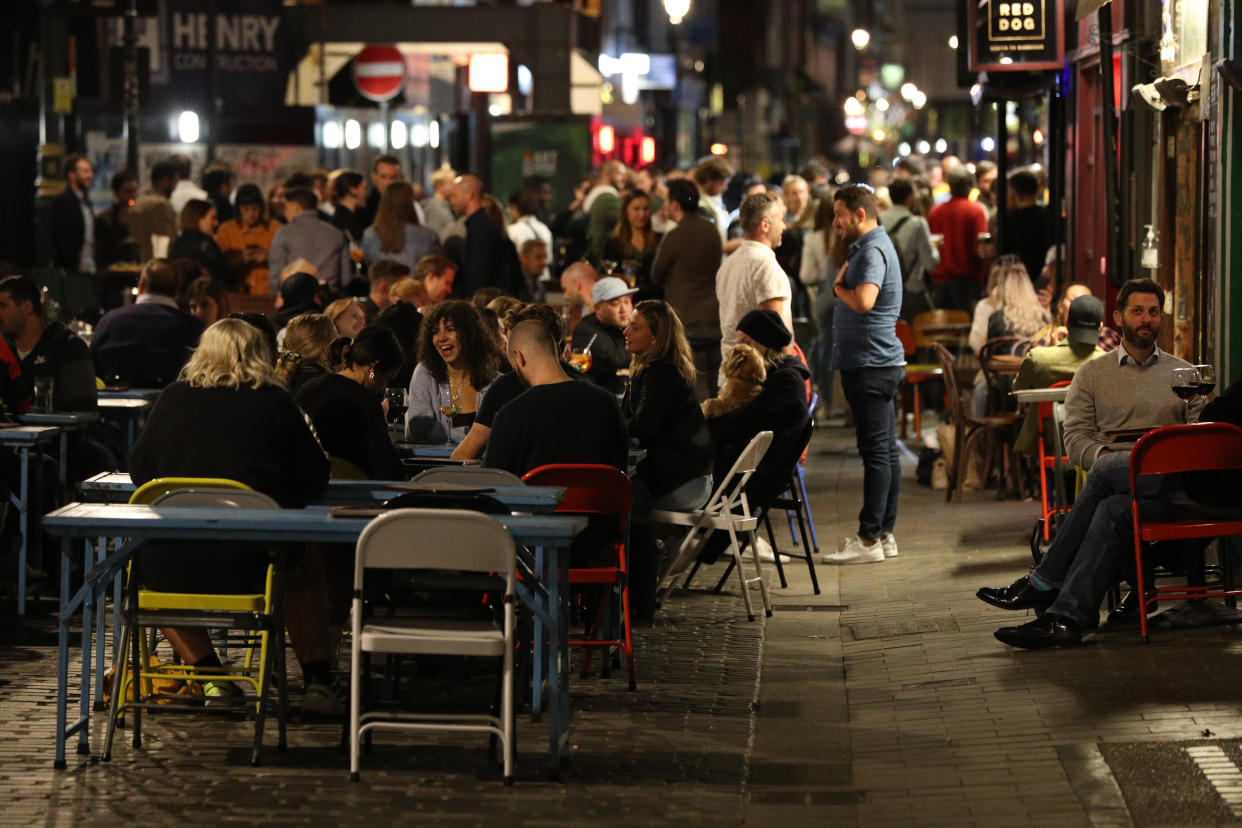 Young people outside the Blue Posts pub in Berwick Street, Soho, London. People in England will be banned from meeting in groups of more than six from Monday as ministers try to tackle the rising number of coronavirus cases across the UK.