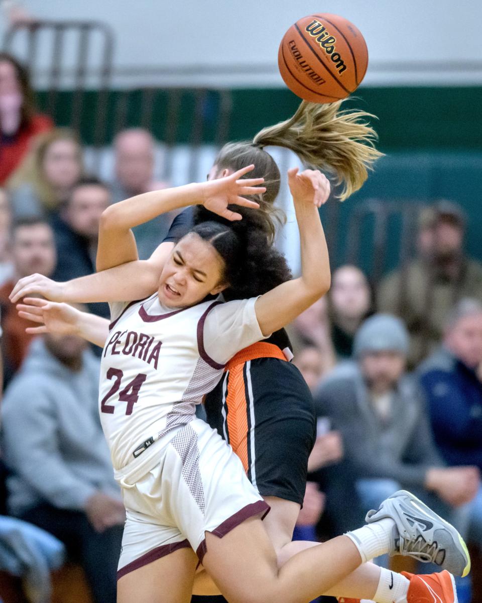 Peoria High's Allannah Jackson (24) collides with Washington's Carly Vaughn while chasing a loose ball in the second half of the Class 3A Girls Basketball Richwoods Sectional title game Thursday, Feb. 23, 2023 at Richwoods High School. The Lions advanced to the Pontiac supersectional with a 35-29 win over the Panthers.