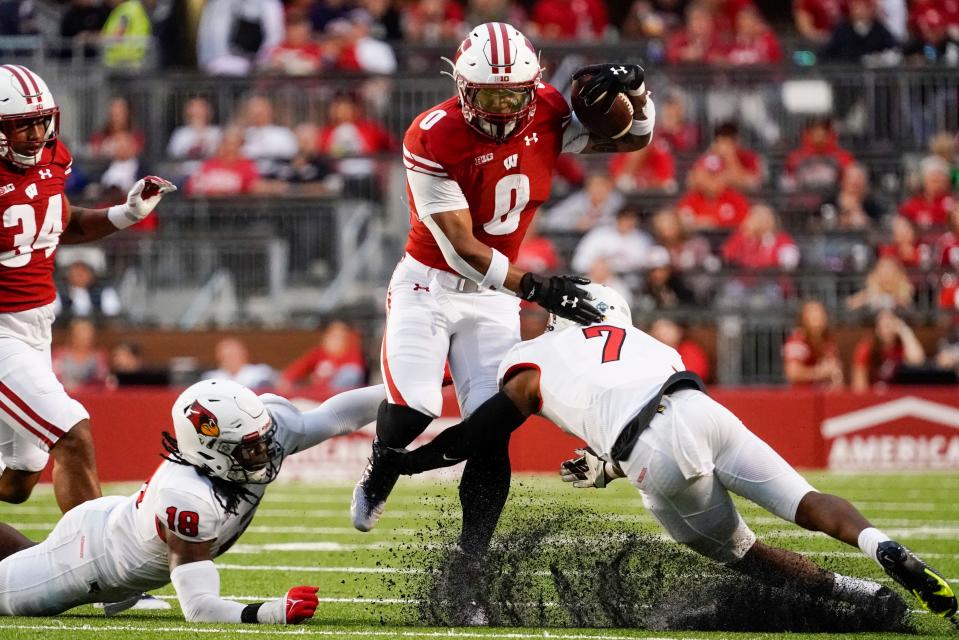 Wisconsin's Braelon Allen (0) runs past Illinois State's Franky West (7) and Jeremiah Jordan (18) during the first half of an NCAA college football game Saturday, Sept. 3, 2022, in Madison, Wis. (AP Photo/Morry Gash)