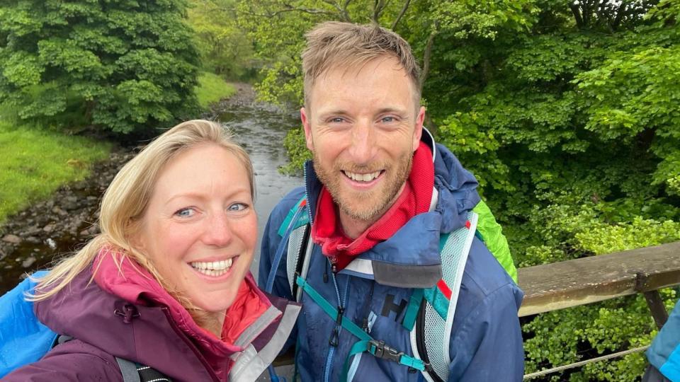 Luke Hames-Brown is on the right, wearing a waterproof coat and carrying a rucksack; Kate, his wife, is wearing a purple coat and is also carrying a rucksack