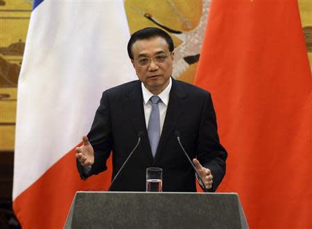 Chinese Premier Li Keqiang gives an address during a news conference with French Prime Minister Jean-Marc Ayrault (not pictured) in the Great Hall of the People in Beijing December 6, 2013. REUTERS/Mark Ralston/Pool