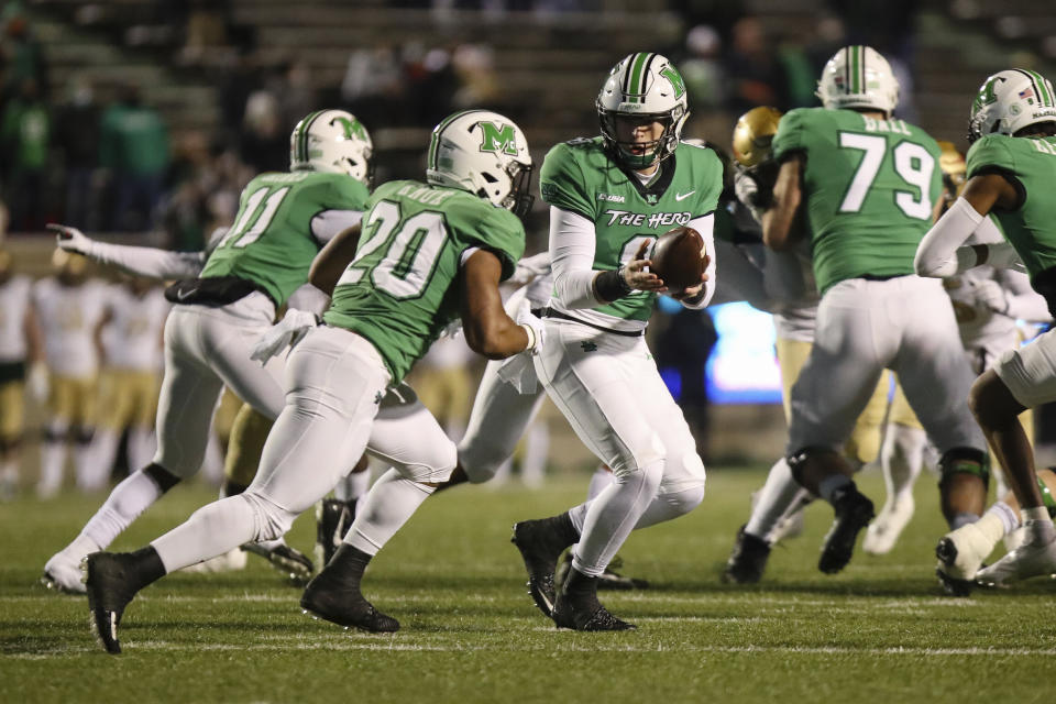 Marshall quarterback Grant Wells (8) hands off to teammate Brenden Knox (20) during an NCAA college football game for the Conference USA Football Championship on Friday, Dec. 18, 2020, in Huntington, W.Va. (Sholten Singer/The Herald-Dispatch via AP)