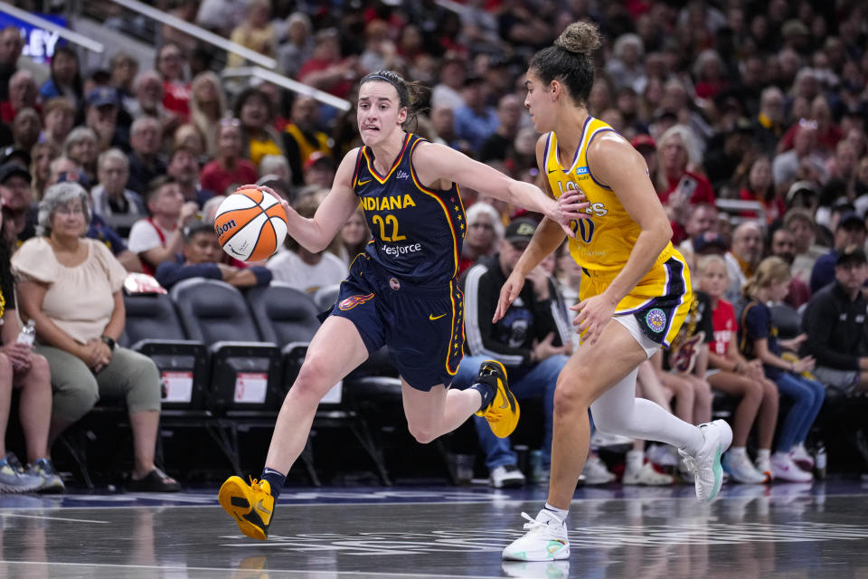 Indiana Fever guard Caitlin Clark (22) drives past Los Angeles Sparks guard Kia Nurse (10) in the second half of a WNBA basketball game in Indianapolis, Wednesday, Sept. 4, 2024. (AP Photo/Michael Conroy)