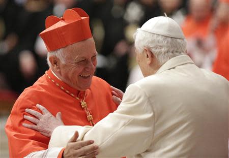 Former Pope Benedict embraces newly elected cardinal Mario Ricardo Ezzati Andrello of Chile during a consistory ceremony in Saint Peter's Basilica at the Vatican February 22, 2014. REUTERS/Max Rossi