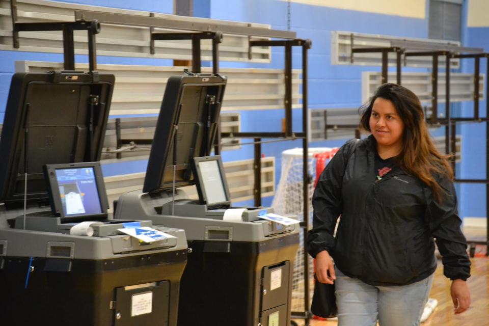 Evelin Reyes exits the voting area at Gaudet Middle School after casting her ballot. After becoming a U.S. citizen in September, the Presidential Primary was the first time Reyes had voted.