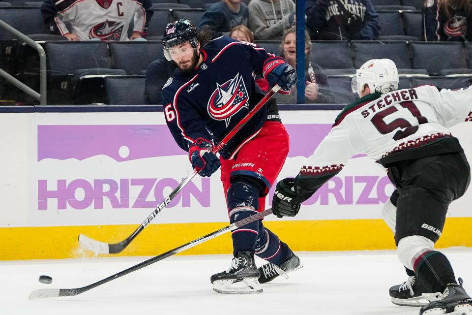 Nov 16, 2023; Columbus, Ohio, USA; Columbus Blue Jackets left wing Kirill Marchenko (86) shoots past Arizona Coyotes defenseman Troy Stecher (51) during the third period of the NHL hockey game at Nationwide Arena. The Blue Jackets lost 3-2.