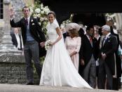 <p>The groom made his first appearance after the church ceremony, wearing pinstriped grey trousers, a light blue waistcoat and long tailored black coat. (Photo: PA) </p>