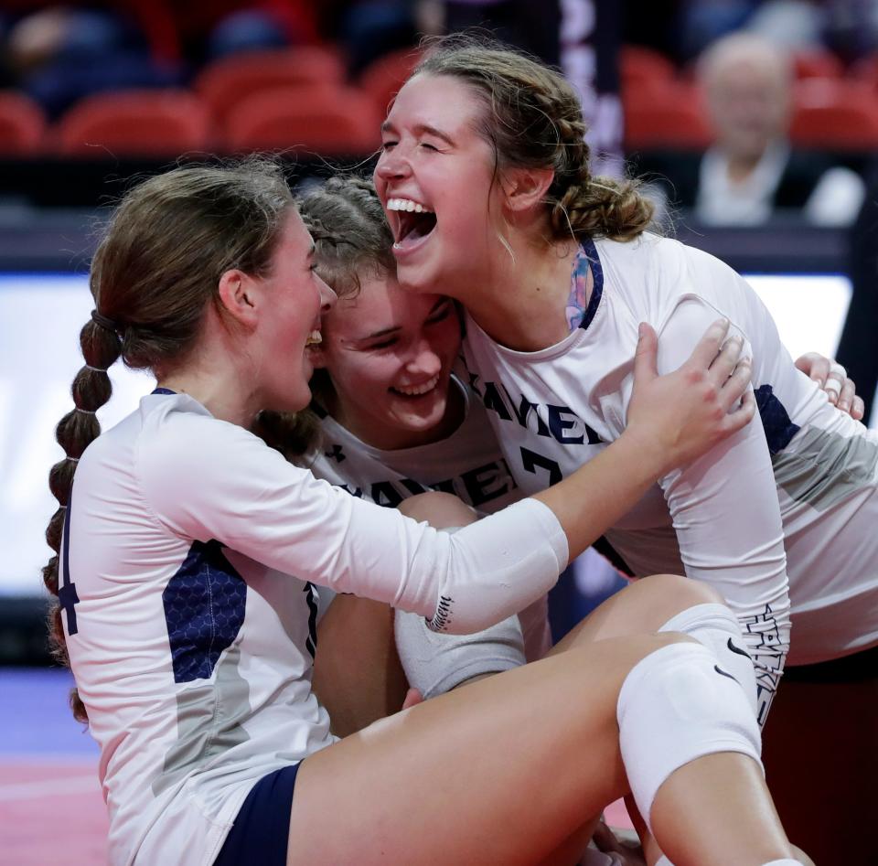 Xavier's Madison Daley, right, hugs teammates after the Hawks won the WIAA Division 2 state title against Sauk Prairie on Nov. 5, 2022, at the Resch Center in Ashwaubenon.