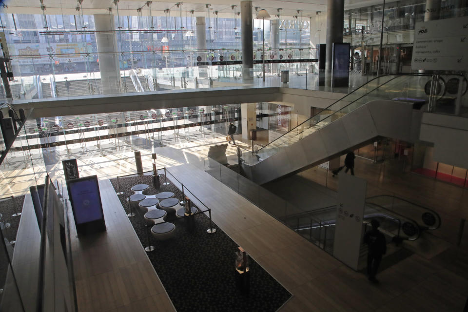 A view of the empty shopping mall at La Defense business district in Paris, Wednesday, March 18, 2020. France is imposing nationwide restrictions on how far from their homes people can go and for what purpose as part of the country's strategy to stop the spread of the new coronavirus. For most people, the new coronavirus causes only mild or moderate symptoms, such as fever and cough. For some, especially older adults and people with existing health problems, it can cause more severe illness, including pneumonia. (AP Photo/Michel Euler)