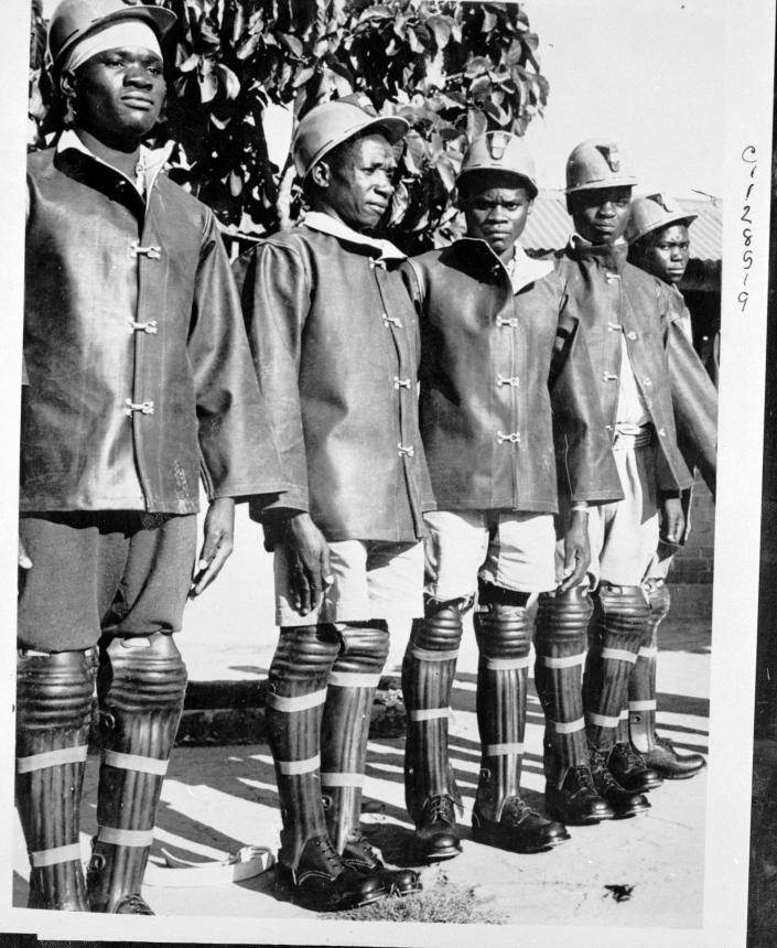 Men are dressed for underground work in Northern Rhodesia's copper mines.