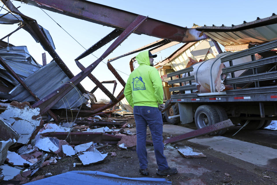 Patrick Crull tours the damage surrounding his home and farm on North Tolles Road with his family Friday morning, Feb. 9, 2024, after a confirmed tornado went through the area just northwest of Evansville, Wis., the evening before. The tornado was the first-ever reported in February in the state of Wisconsin, according to the National Weather Service. (Anthony Wahl//The Janesville Gazette via AP)