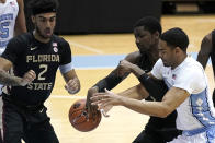 North Carolina forward Garrison Brooks, right, and Florida State center Tanor Ngom struggle for the ball while Florida State guard Anthony Polite (2) looks on during the first half of an NCAA college basketball game in Chapel Hill, N.C., Saturday, Feb. 27, 2021. (AP Photo/Gerry Broome)