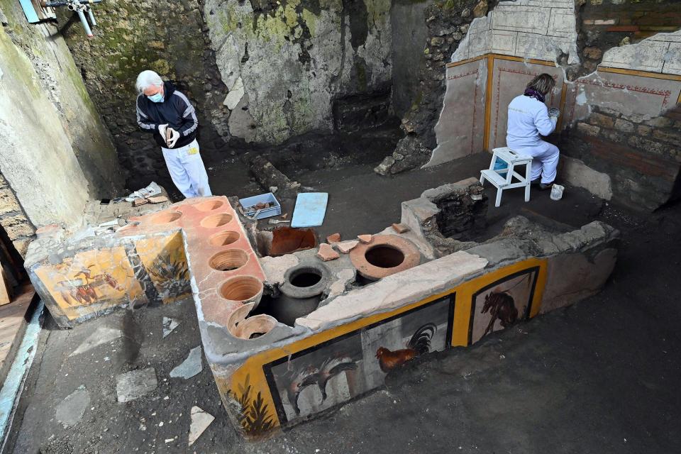 This picture released on December 26, 2020 by the Pompei Press Office shows a thermopolium, a sort of street "fast-food" counter in ancient Rome, that has been unearthed in Pompei, decorated with polychrome motifs and in an exceptional state of preservation
