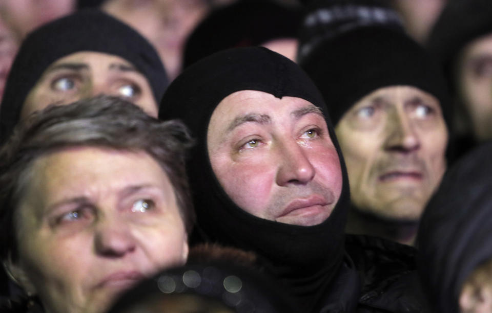 People listen to former Ukrainian prime minister Yulia Tymoshenko in central Kiev, Ukraine, Saturday, Feb. 22, 2014. Hours after being released from prison, former Ukrainian prime minister and opposition icon Yulia Tymoshenko praised the demonstrators killed in violence this week as heroes.(AP Photo/Efrem Lukatsky)