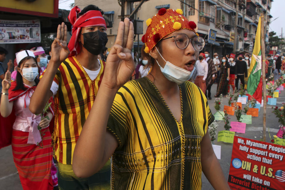 CORRECTS DATE - Anti-coup protesters shout slogans during a rally in Yangon, Myanmar on Thursday March 25, 2021. Protesters against last month’s military takeover in Myanmar returned to the streets in large numbers Thursday, a day after staging a “silence strike” in which people were urged to stay home and businesses to close for the day. (AP Photo)