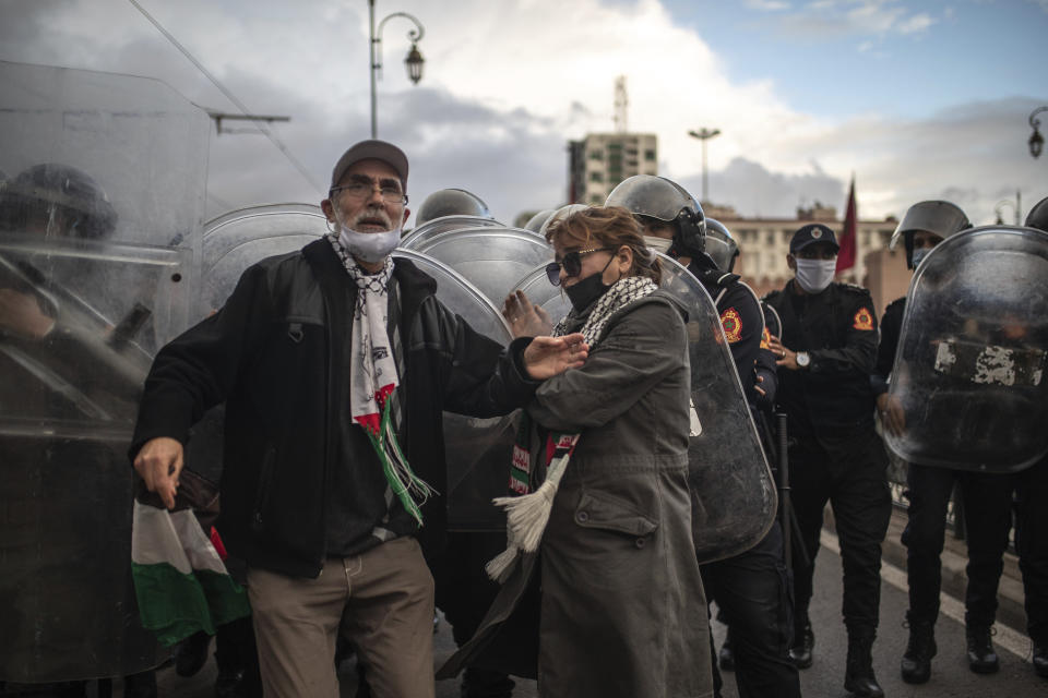 Protesters against the visit of Israeli Defence Minister Benny Gantz to Morocco are dispersed by security forces in Rabat, Wednesday, Nov. 24, 2021. Israel and Morocco signed a landmark agreement Wednesday that lays the foundation for security cooperation, intelligence sharing, and future arms sales. (AP Photo/Mosa'ab Elshamy)