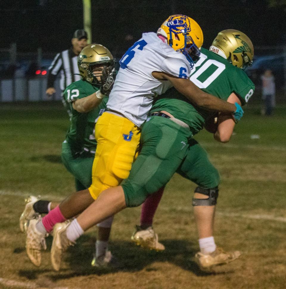 Mason Ivey of St. Mary Catholic Central drags Jefferson's Malachi Pribyl with him as he scores a touchdown during a 28-0 SMCC win Friday night. Patrick Lipford (12) helps push them across the goal line.