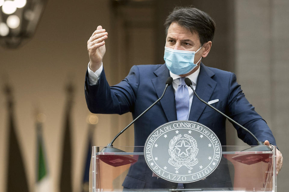 Italian Premier Giuseppe Conte announces new rules to curb the spread of COVID-19, in Rome, Sunday, Oct. 25, 2020. For at least the next month, people outdoors except for small children must now wear masks in all of Italy, gyms, cinemas and movie theaters will be closed, ski slopes are off-limits to all but competitive skiers and cafes and restaurants must shut down in early evenings, under a decree signed on Sunday by Italian Premier Giuseppe Conte, who ruled against another severe lockdown despite a current surge in COVID-19 infections. (Roberto Monaldo/LaPresse via AP)