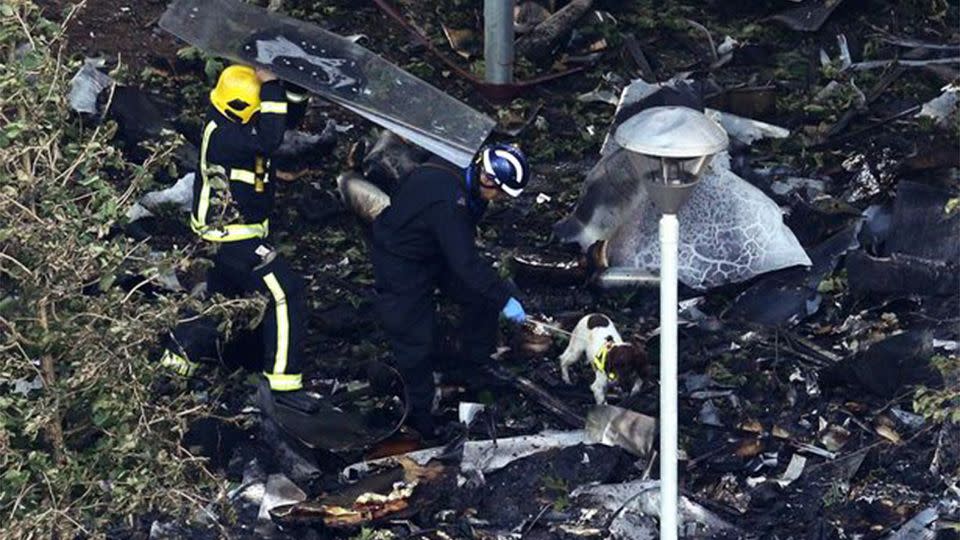 Firefighters search through the rubble in the inferno's aftermath. Source: Getty Images