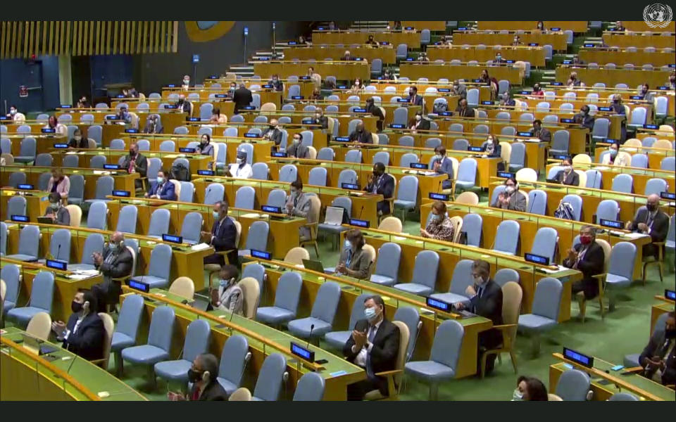 In this image made from UNTV video, people applaud after a pre-recorded message was played during the 75th session of the United Nations General Assembly, Tuesday, Sept. 22, 2020, at U.N. headquarters in New York. The U.N.'s first virtual meeting of world leaders started Tuesday with pre-recorded speeches from some of the planet's biggest powers, kept at home by the coronavirus pandemic that will likely be a dominant theme at their video gathering this year. (UNTV via AP)