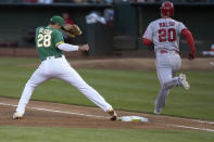 Oakland Athletics first baseman Matt Olson (28) steps to the bag to complete the double play against Los Angeles Angels' Jared Walsh (20) during the fifth inning of a baseball game Friday, May 28, 2021, in Oakland, Calif. Justin Upton was out at second base. (AP Photo/Tony Avelar)