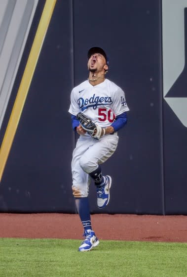 The Dodgers' Mookie Betts celebrates after making a leaping catch.