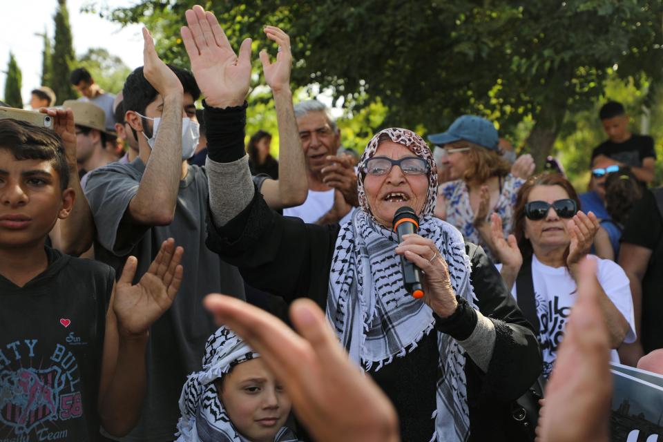 Protesters take part in a demonstration on 11 June against the proposed eviction of Palestinian families in Sheikh Jarrah (Reuters)