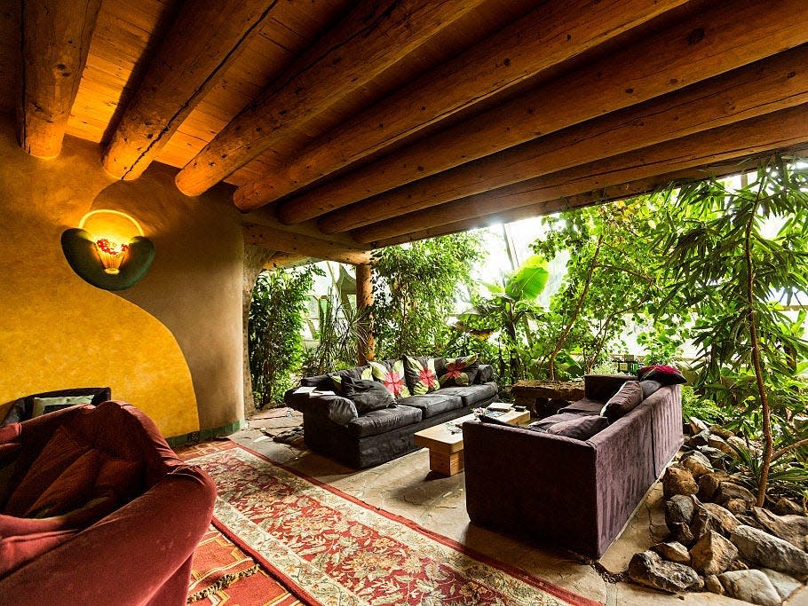 phoenix earthship living area with tree views