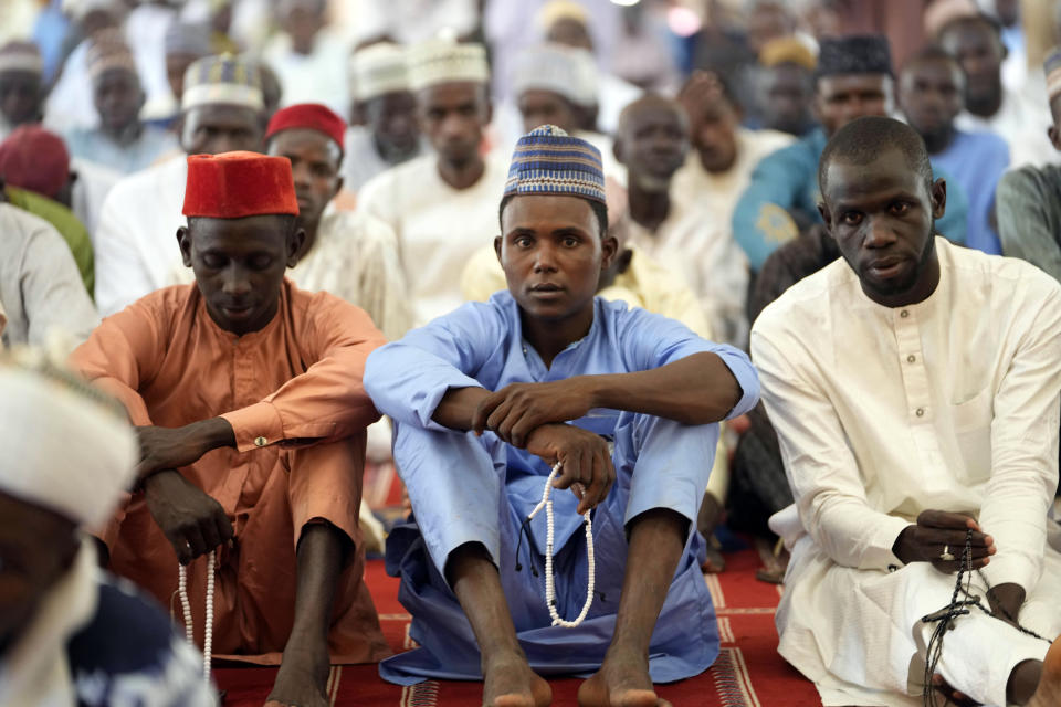 Muslim faithful listen to a sermons by an Imam, before a traditional Friday prayers at the Moddibo Adama Mosque in Yola Nigeria, Friday, Feb. 24, 2023. On Feb. 25, voters will choose among 18 candidates in a first-round vote to succeed incumbent President Muhammadu Buhari, but despite being Africa's largest economy and and one of its top oil producers, Nigeria is in economic crisis. (AP Photo/Sunday Alamba)