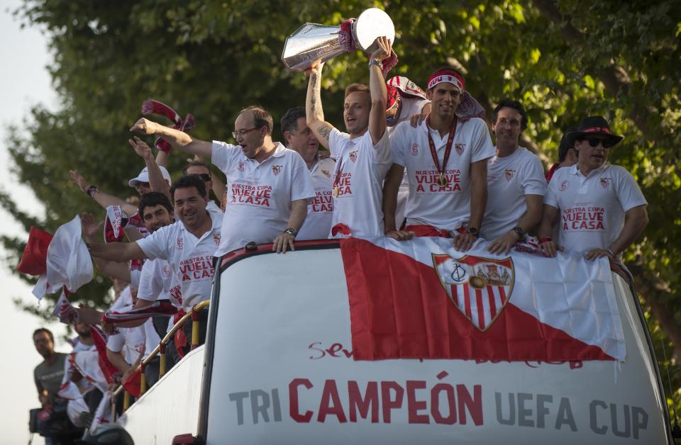 A bus with the Sevilla FC football team parade as they celebrate their Europa League trophy in the streets of Sevilla on May 15, 2014. (GOGO LOBATO/AFP/Getty Images)