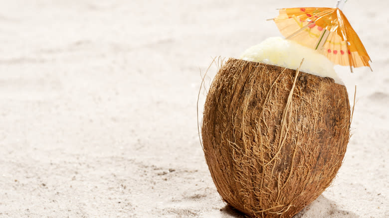 Coconut drink on sand