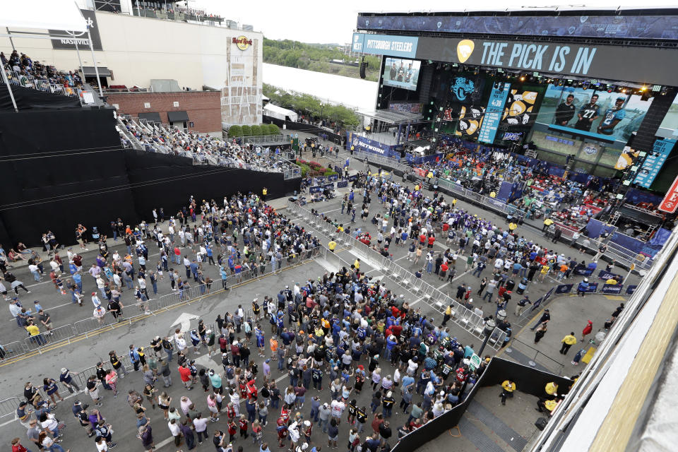 People attend the final day of the NFL football draft Saturday, April 27, 2019, in Nashville, Tenn. (AP Photo/Mark Humphrey)