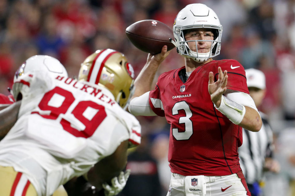 FILE- In this Sunday, Oct. 28, 2018, file photo, Arizona Cardinals quarterback Josh Rosen (3) throws as San Francisco 49ers defensive tackle DeForest Buckner (99) pursues during the second half of an NFL football game in Glendale, Ariz. Many teams think it's best to throw rookie QBs right into the fire to learn on the job. Others prefer to gradually work them into the offense. Then, there are some who believe it's more beneficial to have them grab a cap and a clipboard and take it all in from the sideline. (AP Photo/Ralph Freso, File)