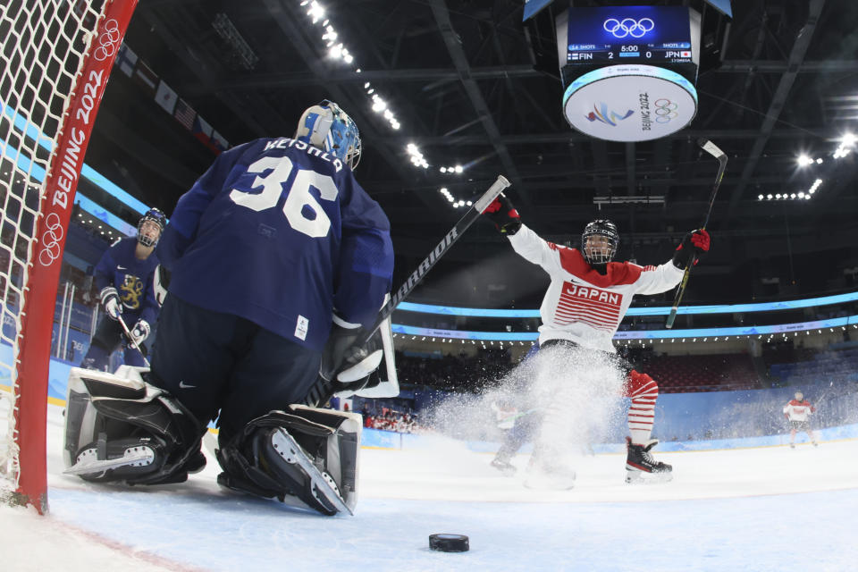 Japan's Akane Shiga, right, scores against Finland goalkeeper Anni Keisala (36) during a women's quarterfinal hockey game at the 2022 Winter Olympics, Saturday, Feb. 12, 2022, in Beijing. (Song Yanhua/Pool Photo via AP)