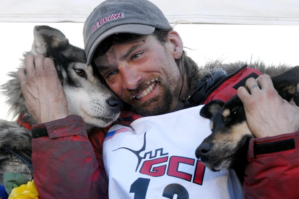 Lance Mackey and his lead dogs, Larry and Lippy, celebrate after winning the 2007 Iditarod Sled Dog Race in Nome, Alaska, March 13, 2007. (Photo by Bob Hallinen/Anchorage Daily News/Tribune News Service via Getty Images)