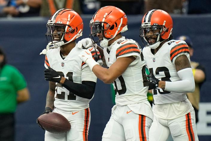 Cleveland Browns cornerback Denzel Ward (21) is congratulated by Greg Newsome II (20) and John Johnson III (43) after Ward recovered a Texan fumble to score during the second half of an NFL football game between the Cleveland Browns and Houston Texans in Houston, Sunday, Dec. 4, 2022. (AP Photo/Eric Gay)