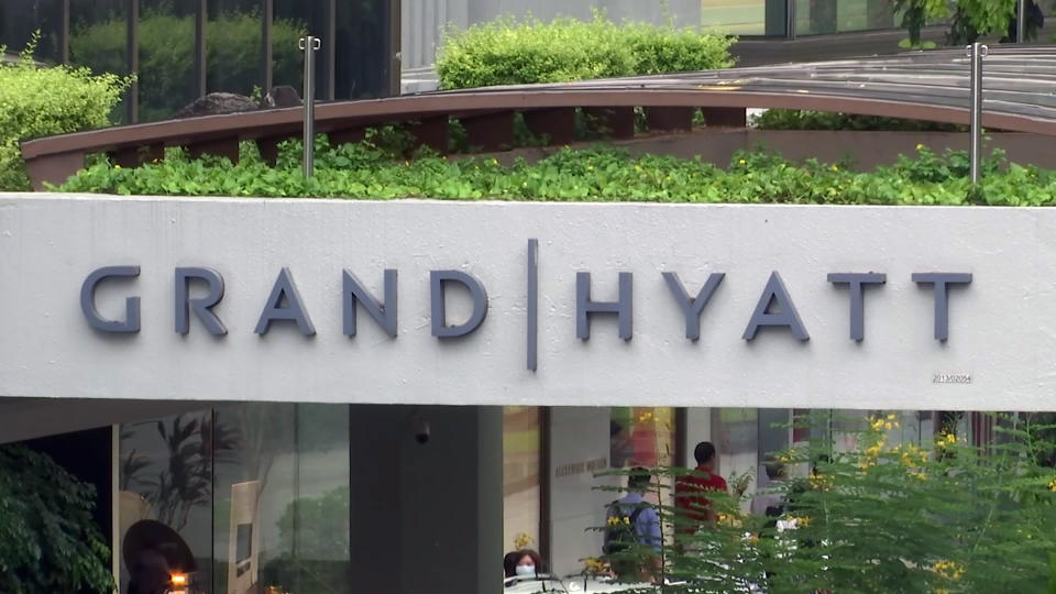 This image made from video shows the exterior of the Grand Hyatt hotel in Singapore, Monday, Feb. 10, 2020. A middle-aged businessman from southern England unwittingly carried the new virus across two continents and unwittingly infected at least 11 people in three countries, in just one example that illustrates how China's outbreak could turn into a global pandemic amid fast-moving international travel. The businessman contracted the virus while attending a gas industry conference in the Grand Hyatt in Singapore in January. (AP Photo)