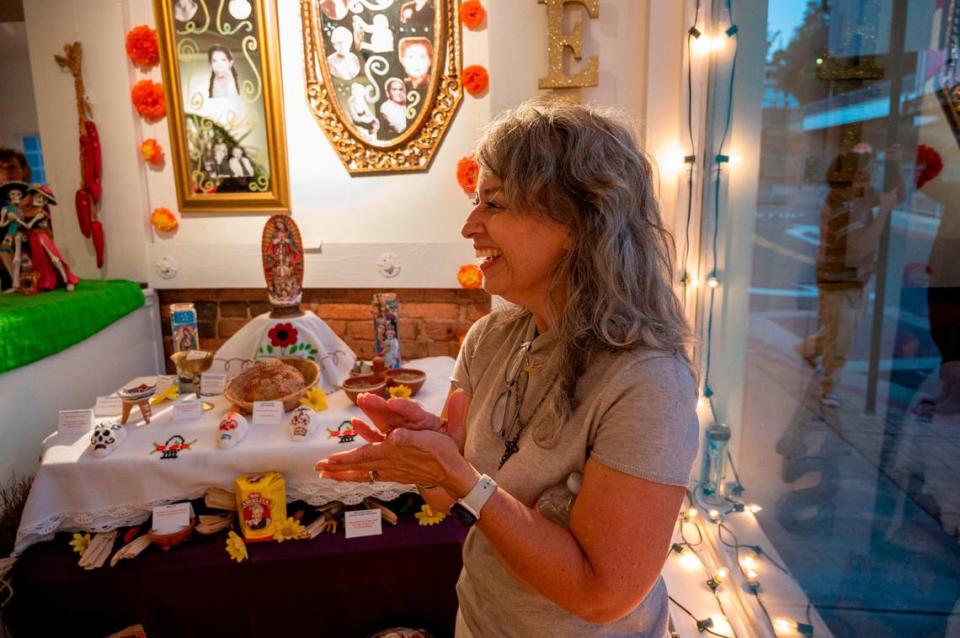 Penny Smart talks about her abuela making tortillas by hand, at an ofrena she decorated in her honor, at Center Street Gallery on Thursday, Oct. 19, 2023, for Placerville’s Dia de los Muertos.
