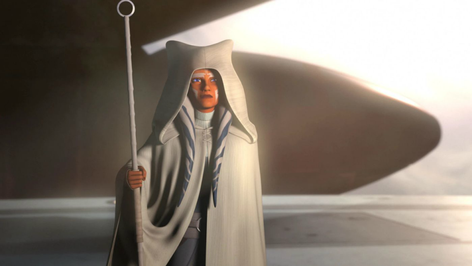 Ahsoka Tano in a hooded white robe holds a staff on Star Wars Rebels