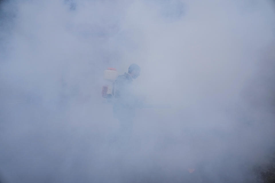 A municipal employee fumigates outside the venue of G20 tourism working group meeting in Srinagar, Indian controlled Kashmir, Wednesday, May 17, 2023. Indian authorities have stepped up security and deployed elite commandos to prevent rebel attacks during the meeting of officials from the Group of 20 industrialized and developing nations in the disputed region next week. (AP Photo/Mukhtar Khan)