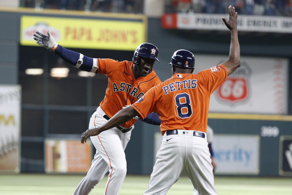 Houston Astros' Yordan Alverez celebrates with third base coach Gary Pettis after hitting a solo home run off New York Yankees starting pitcher Domingo German during the first inning in the second game of a baseball doubleheader Thursday, July 21, 2022, in Houston. (AP Photo/Kevin M. Cox)