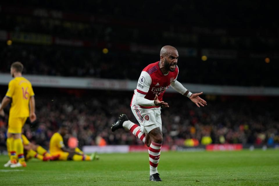 Lacazette wheels away to celebrate after his stoppage-time equaliser (AP)