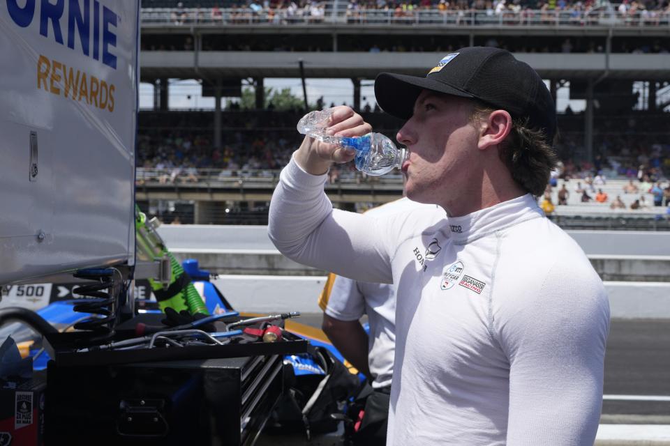 Kyffin Simpson takes a drink of water following a practice session for the Indianapolis 500 auto race at Indianapolis Motor Speedway, Friday, May 24, 2024, in Indianapolis. (AP Photo/Darron Cummings)