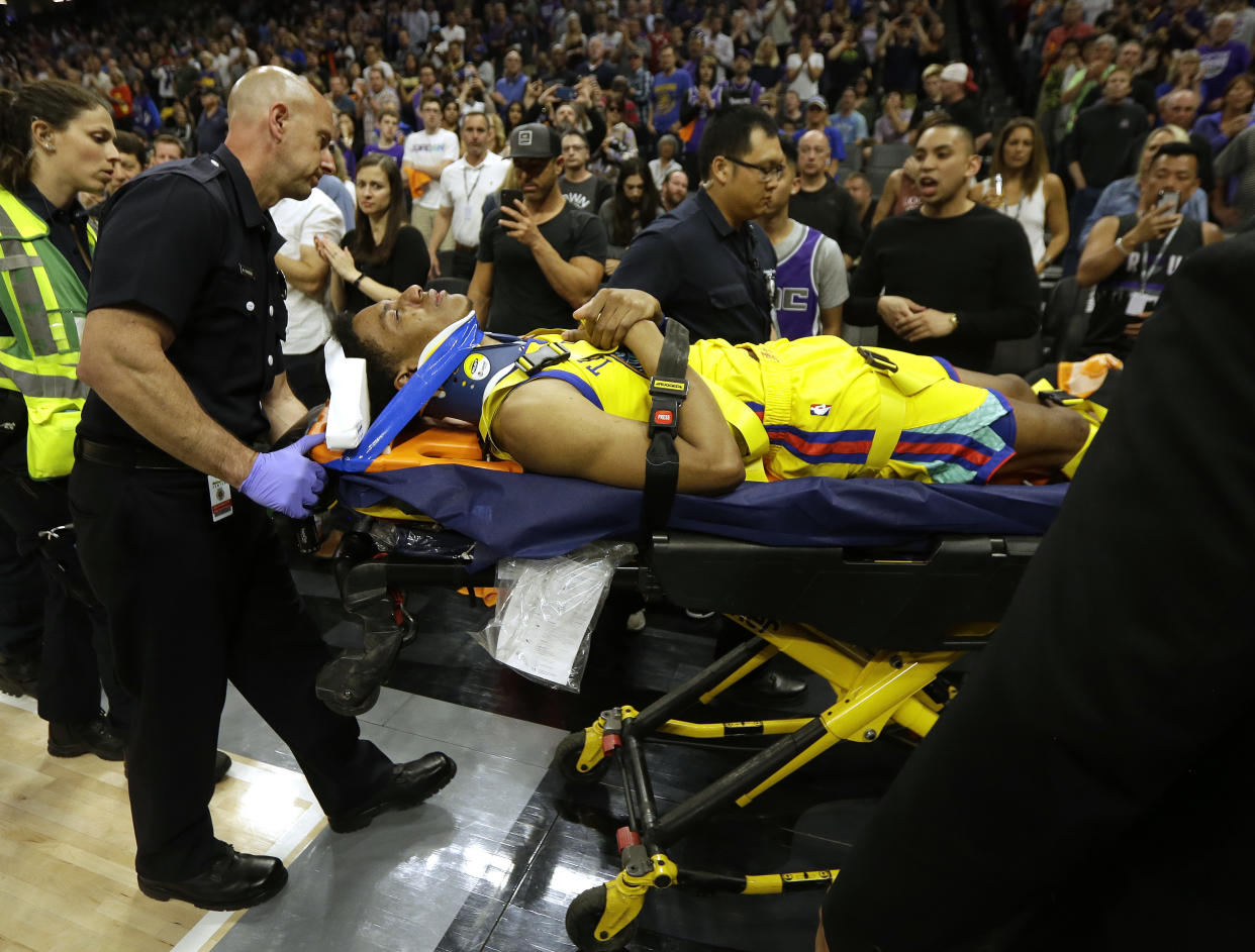 Warriors guard Patrick McCaw is taken off the court on a stretcher after falling hard to the floor late in the third quarter following a Flagrant 1 foul by the Kings’ Vince Carter on Saturday. (AP)